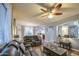 Inviting living room with reclining leather furniture, ceiling fan, and neutral decor throughout at 3270 W White Canyon Rd, San Tan Valley, AZ 85144