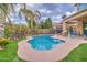 Relaxing pool with custom concrete, manicured yard, and palm trees for a tropical feel at 3270 W White Canyon Rd, San Tan Valley, AZ 85144