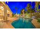 Sparkling swimming pool area with tropical landscaping and ambient lighting for relaxation and enjoyment at 3270 W White Canyon Rd, San Tan Valley, AZ 85144