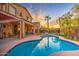 Beautiful backyard pool with tropical landscaping and a covered patio perfect for outdoor entertaining at 3270 W White Canyon Rd, San Tan Valley, AZ 85144