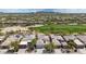 Overhead shot of residential area featuring well-maintained homes, golf course, and desert landscaping at 32771 N 70Th St, Scottsdale, AZ 85266