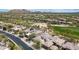 Aerial view showcasing homes, golf course, and mountain views in a desert community at 32771 N 70Th St, Scottsdale, AZ 85266