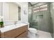 Modern bathroom featuring a stylish vanity, sleek mirror, and an elegant glass-enclosed shower with green tile at 32771 N 70Th St, Scottsdale, AZ 85266