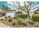 Landscaped front yard featuring native desert plants and a vibrant tree adding curb appeal at 32771 N 70Th St, Scottsdale, AZ 85266