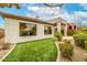 Home exterior with manicured lawn, desert landscaping, and well-placed windows at 32771 N 70Th St, Scottsdale, AZ 85266