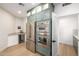 Gourmet kitchen with stainless appliances, green cabinets, beverage center, and sleek design at 32771 N 70Th St, Scottsdale, AZ 85266