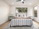 Light, airy main bedroom with a comfortable bed, ceiling fan, and view to the outdoors at 32771 N 70Th St, Scottsdale, AZ 85266