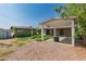 A spacious backyard, featuring gravel and grass with a covered patio and additional structure at 339 E 9Th Dr, Mesa, AZ 85210