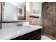 Bathroom with white vanity, brown tiling, and white storage cabinet at 339 E 9Th Dr, Mesa, AZ 85210