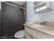 Bathroom features a walk-in shower, a traditional vanity with marble top, and mirrored storage at 339 E 9Th Dr, Mesa, AZ 85210