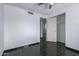 A well-lit bedroom with a ceiling fan, closet, and doorway leading to another room at 339 E 9Th Dr, Mesa, AZ 85210