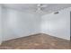 Neutral bedroom with ceiling fan, tile flooring, and white door at 339 E 9Th Dr, Mesa, AZ 85210