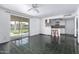 Inviting living area with access to the kitchen and patio, featuring dark tile flooring and a ceiling fan at 339 E 9Th Dr, Mesa, AZ 85210