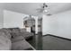Bright living room featuring dark tile flooring and a comfortable sectional sofa with accent pillows at 339 E 9Th Dr, Mesa, AZ 85210