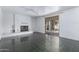 Spacious living room with a white brick fireplace, tile floors, and sliding glass doors to the backyard at 339 E 9Th Dr, Mesa, AZ 85210
