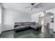 Well-lit living room with tile flooring, a ceiling fan, and sectional sofa for comfortable lounging at 339 E 9Th Dr, Mesa, AZ 85210