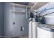 Utility room featuring a water filtration system, shelves, and laundry-related connections at 339 E 9Th Dr, Mesa, AZ 85210