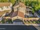 Aerial shot showcases a two-story home with a tile roof, lush greenery, and a private backyard at 3678 E Yeager Ct, Gilbert, AZ 85295