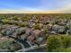 An aerial view highlighting cozy homes with backyard patios, garages, and paved driveways in a well-planned community at 3678 E Yeager Ct, Gilbert, AZ 85295
