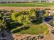 Aerial view looking down at a well-maintained park with picnic tables and a green field for recreation at 3678 E Yeager Ct, Gilbert, AZ 85295