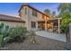 Attractive backyard with a covered patio, mature landscaping, and desert-friendly gravel at 3678 E Yeager Ct, Gilbert, AZ 85295