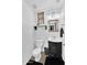 Stylish half bathroom features elegant fixtures, patterned wallpaper, and decorative shelving at 3678 E Yeager Ct, Gilbert, AZ 85295