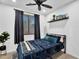 This bedroom features a large window, blackout curtains, and modern decor at 3678 E Yeager Ct, Gilbert, AZ 85295