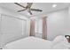 This bedroom features a ceiling fan, closet, and white walls at 3678 E Yeager Ct, Gilbert, AZ 85295