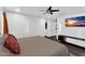 Spacious bedroom with neutral tones, a ceiling fan, and a television at 3678 E Yeager Ct, Gilbert, AZ 85295