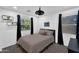 This bedroom features a ceiling fan and two windows with shelves and blackout curtains at 3678 E Yeager Ct, Gilbert, AZ 85295