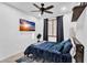 This bedroom features a ceiling fan, a window, and modern gray flooring at 3678 E Yeager Ct, Gilbert, AZ 85295