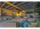 Well-designed covered patio with an outdoor grill, television, and comfortable seating arrangement at 3678 E Yeager Ct, Gilbert, AZ 85295