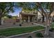 Beautiful two-story home boasting mature trees, a covered porch, and a well-manicured lawn at 3678 E Yeager Ct, Gilbert, AZ 85295