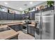 Modern kitchen with stainless steel refrigerator and stove, dark cabinets, and decorative backsplash at 3678 E Yeager Ct, Gilbert, AZ 85295