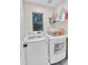 Efficient laundry room with modern, white washer and dryer set and ample storage space at 3678 E Yeager Ct, Gilbert, AZ 85295