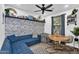 Cozy seating area features a modern blue sofa, painted brick wall, and rustic wood table at 3678 E Yeager Ct, Gilbert, AZ 85295