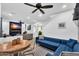Open-concept living space with modern decor, blue sectional and dining area nearby at 3678 E Yeager Ct, Gilbert, AZ 85295