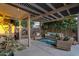Inviting covered patio with comfortable seating, stylish decor, and an outdoor BBQ area at 3678 E Yeager Ct, Gilbert, AZ 85295