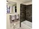 Cozy bathroom with tub, dark tile and decorative details at 3737 E Turney Ave # 223, Phoenix, AZ 85018
