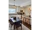 Modern kitchen with sleek appliances, countertop seating, and adjacent dining area at 3737 E Turney Ave # 223, Phoenix, AZ 85018