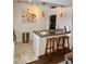 Bright kitchen features a breakfast bar with stone accents, white cabinetry and modern lighting at 3737 E Turney Ave # 223, Phoenix, AZ 85018