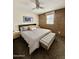Bright main bedroom with a brick accent wall and neutral carpet at 3737 E Turney Ave # 223, Phoenix, AZ 85018