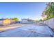 Large backyard area featuring a concrete pad, shed, block fencing, and landscaping with mature trees at 3906 W Aire Libre Ave, Phoenix, AZ 85053
