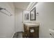 Full bathroom features a mirror, wood vanity and toilet at 3906 W Aire Libre Ave, Phoenix, AZ 85053