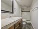 Bathroom with white tiled shower and wood cabinet at 3906 W Aire Libre Ave, Phoenix, AZ 85053