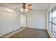 Bedroom with neutral carpet, a ceiling fan, and a view to the outside at 3906 W Aire Libre Ave, Phoenix, AZ 85053