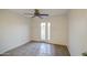 Bright bedroom with double doors and a ceiling fan at 3906 W Aire Libre Ave, Phoenix, AZ 85053