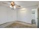 Bright bedroom with carpet, a ceiling fan, and a private ensuite bathroom at 3906 W Aire Libre Ave, Phoenix, AZ 85053