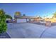 Charming single story home featuring a spacious driveway, two-car garage, and brick accents at 3906 W Aire Libre Ave, Phoenix, AZ 85053