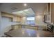 Kitchen with tile floors, lots of counter space and natural light at 3906 W Aire Libre Ave, Phoenix, AZ 85053